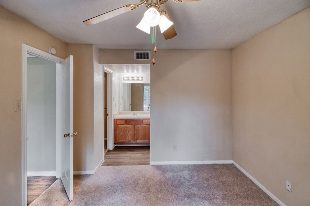 Bedroom with ceiling light at Village Oaks Apartments, Austin, Texas